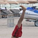 Russell Simmons' yoga stretch on a beach...Wow!