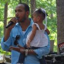 Lyfe Jennings Holds His Daughter While Speaking To The Crowd