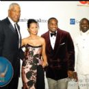 Dr. J and Wife along with Devyne Stephens and Akon pose on the red carpet