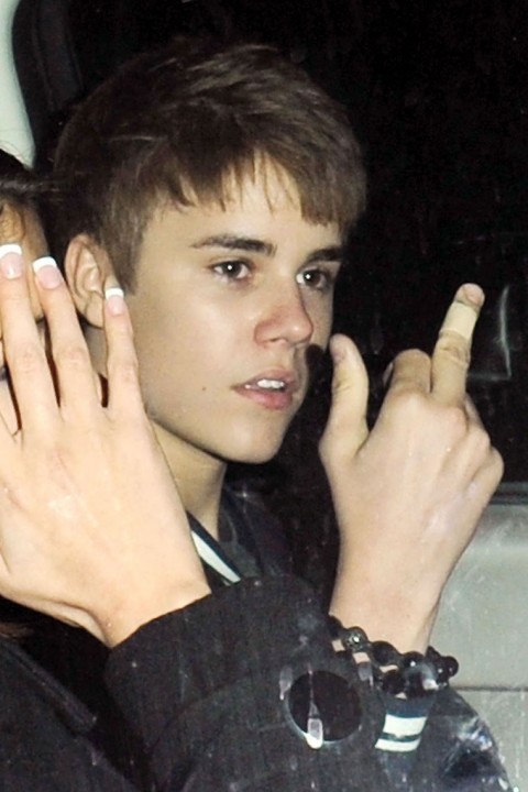 justin bieber middle finger photo. First, Justin Bieber cuts his