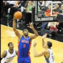 Chris Wilcox of the Pistons shoots over Wizards JaVale McGee