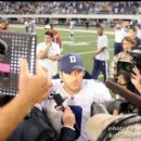 QB Tony Romo speaks to interviewers after the game