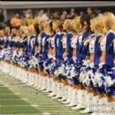 The Cowboys Cheerleaders stand during the National Anthem performance