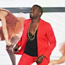 Kanye West rocking a red outfit and a Mr. T starter kit