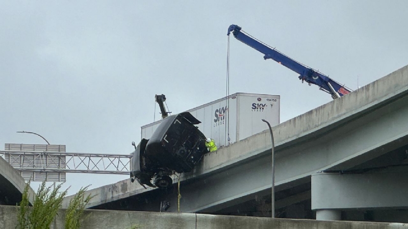Semitruck crash leaves driver dangling