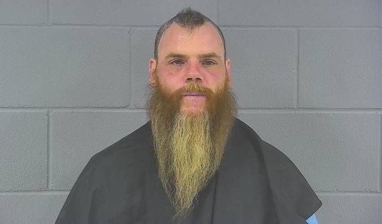 Docs: Driver threatened woman, baby with a gun after Hancock Co. crash
