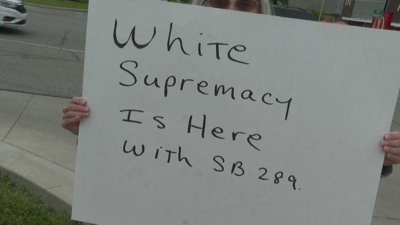 Demonstrators gather during Indiana Lt. Governor Micah Beckwith's town hall event in Zionsville