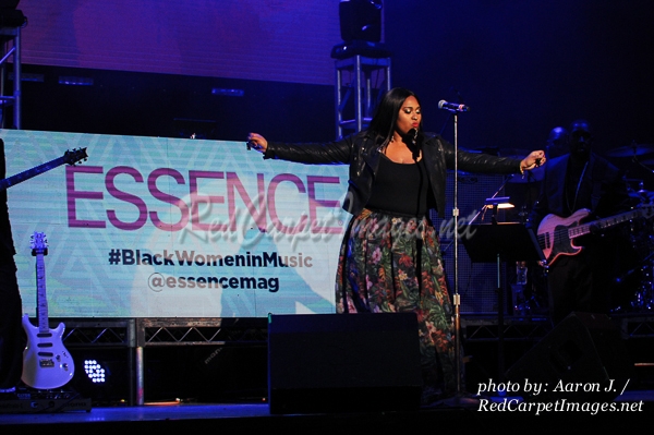 Singer Jazmine Sullivan performing on stage