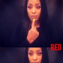 Make the sign for red by making a fist, and extending only your index finger. Use the finger to brush down on your chin.