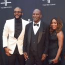 Media Mogul Tyler Perry, Boxer Evander Holyfield, and a Guest attend Tyler Perry's Atlanta Studio Grand Opening