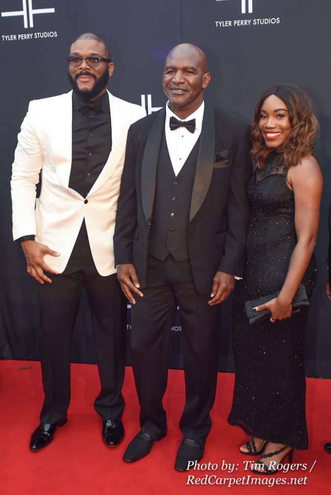 Media Mogul Tyler Perry, Boxer Evander Holyfield, and a Guest attend Tyler Perry's Atlanta Studio Grand Opening