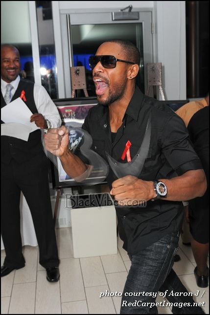 Singer Tank reacts after winning a silent auction item at Big Tigger's Wknd