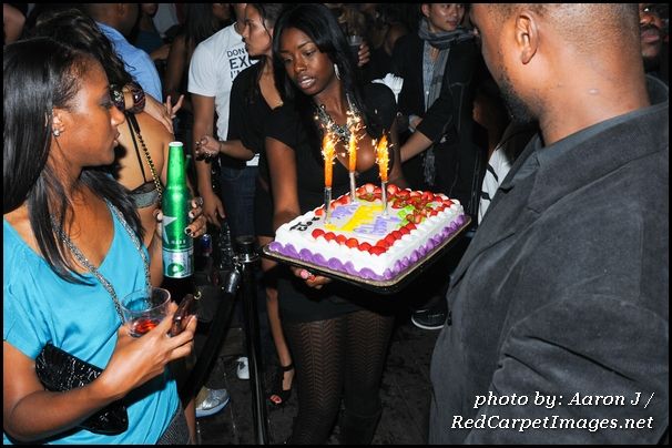 The cake arrives to the VIP section where Willis and Friends celebrate his Birthday