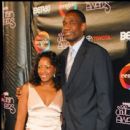 Former NBA Center Dikembe Mutombo and guest on the red carpet