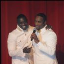 Akon and Devyne Stephens speak to the guest at the event