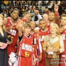 The winning team poses at center court after the game waiting for the MVP to be announced