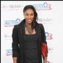 Former WNBA star Lisa Leslie poses for a picture on the magenta carpet