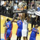 Wizards Kevin Seraphin goes for a dunk against three Pistons players