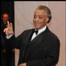 Rev. Al Sharpton gives the peace sign to member of the media on the red carpet