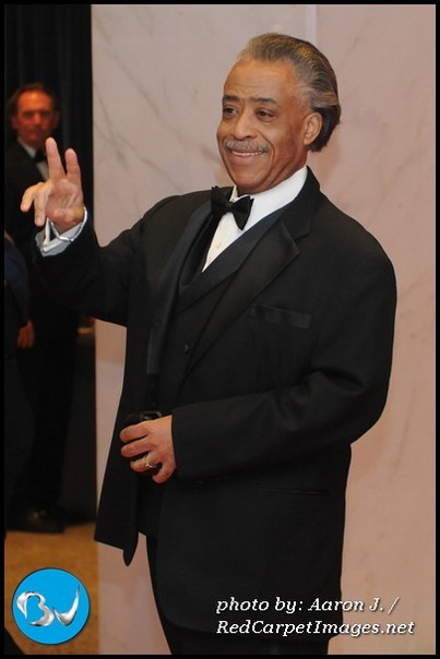 Rev. Al Sharpton gives the peace sign to member of the media on the red carpet