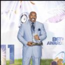 Steve Harvey backstage holds his 2011 BET Award
