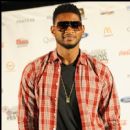 Usher stops to take a picture backstage before his performance at the Superdome