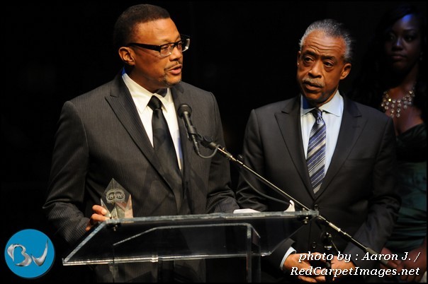 Rev Al Sharpton looks on as Honorable Judge Greg Mathis speaks after receiving his award at the 2011 Triumph Awards