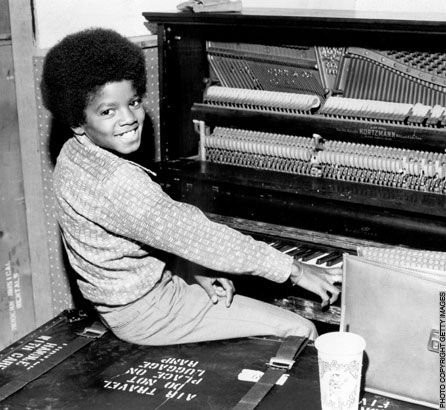A young Michael Jackson at the piano