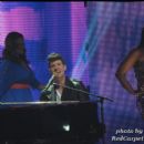 Robin Thicke performs while models work the runway