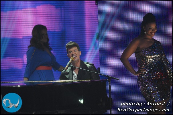 Robin Thicke performs while models work the runway