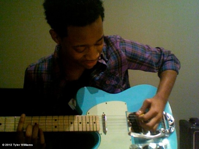 Tyler playing the guitar