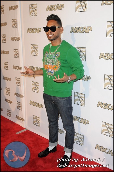 Miguel stops and poses for photographers on the red carpet
